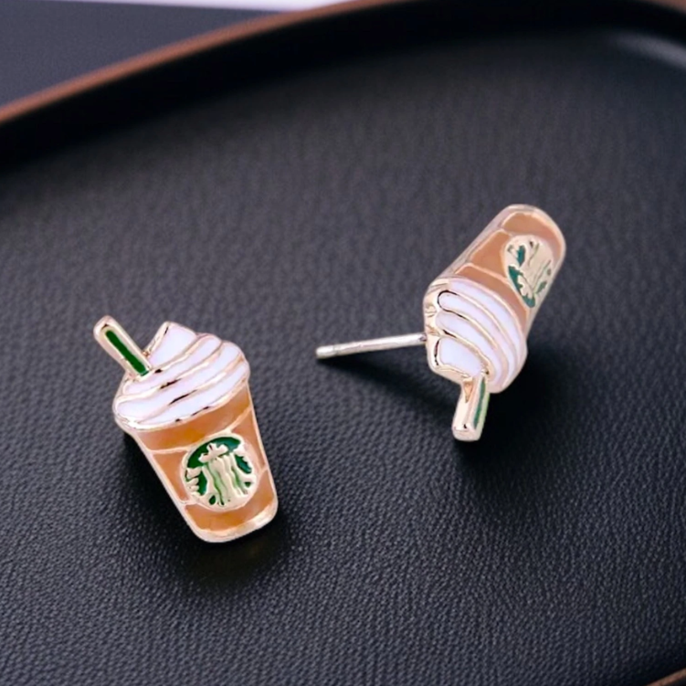 Starbucks cup-shaped earrings on a dark surface