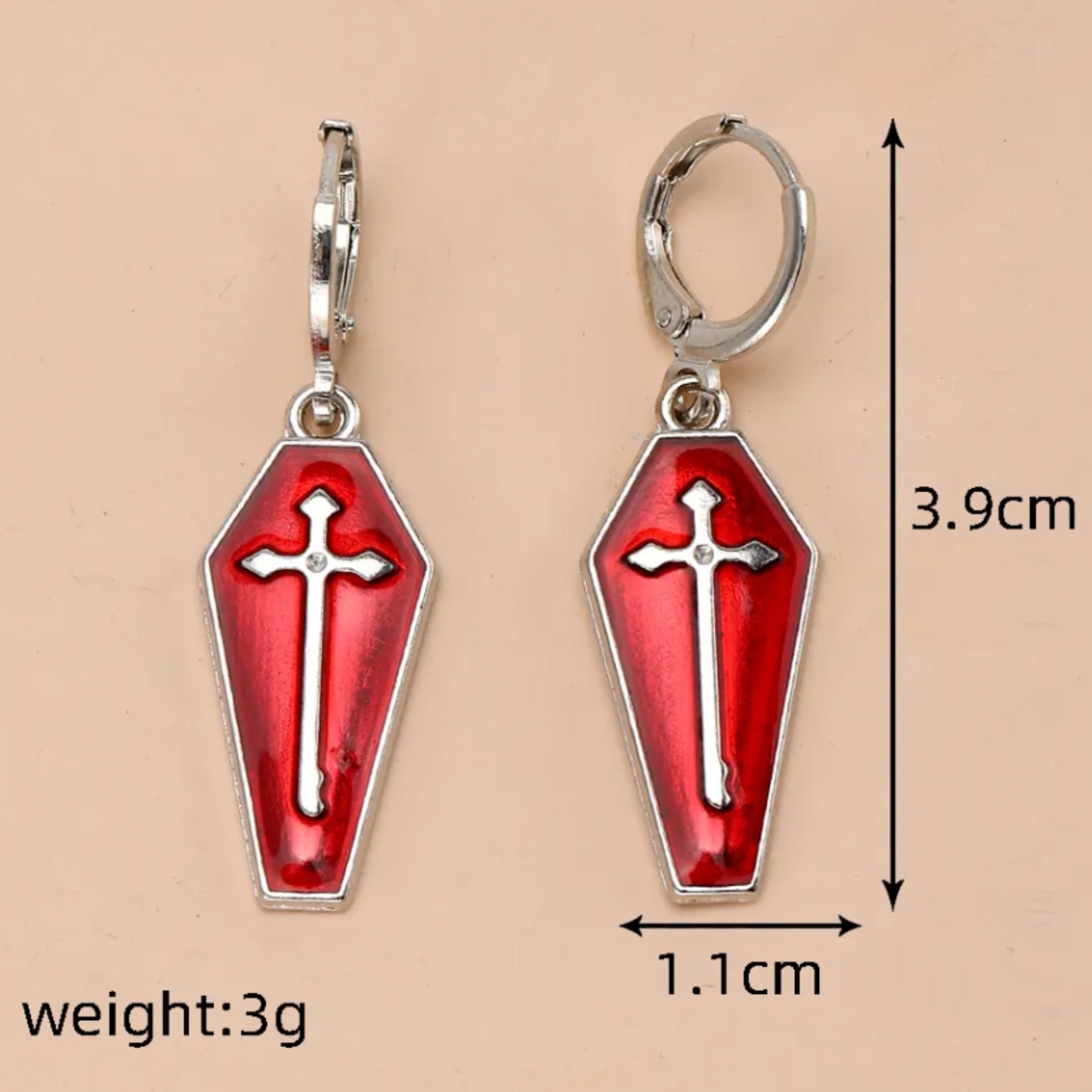 Red coffin-shaped earrings with silver crosses, shown with measurements on a beige background.