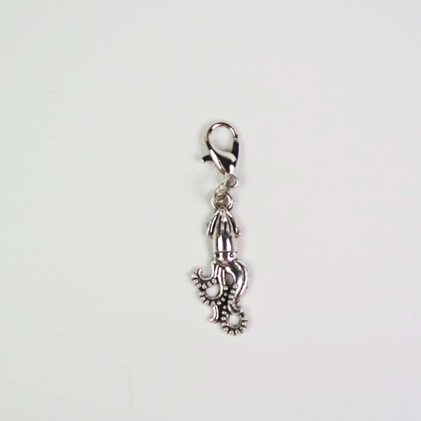 Silver Giant Squid charm with a lobster clasp on a white background