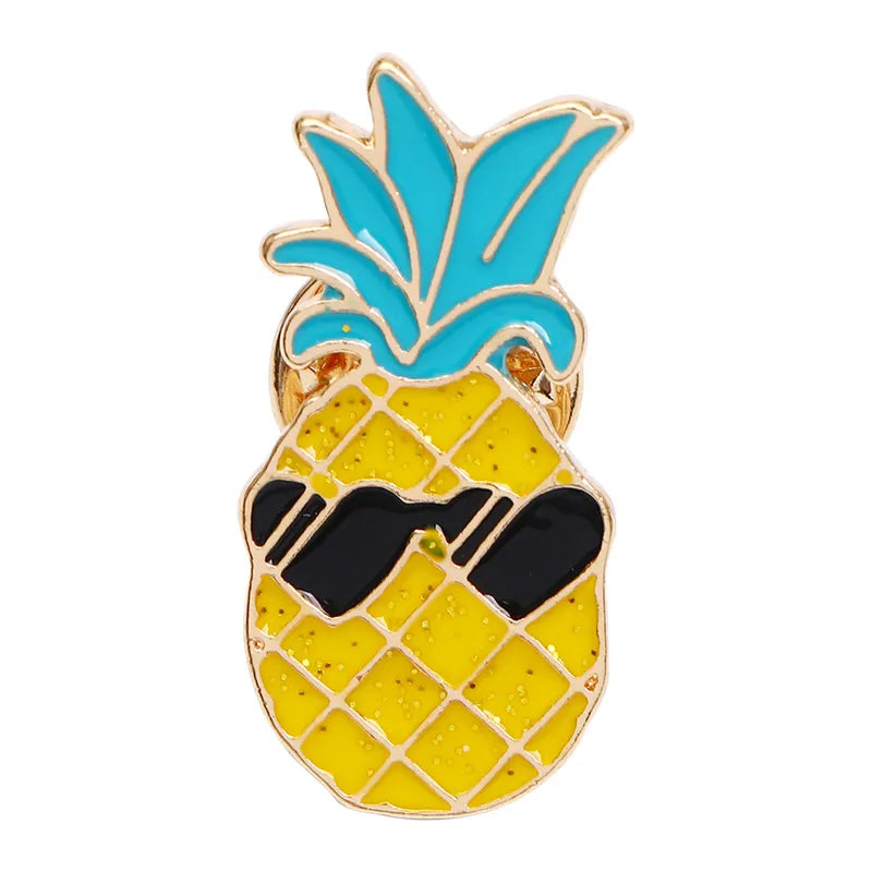 A colorful enamel pin shaped like a pineapple with a sparkle effect and sunglasses.