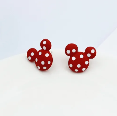 A pair of red and white polka dot mouse ear small stud earrings.