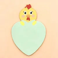 Cute cartoon chicken on a light blue sticky note with a yellow heart, displayed against a pink background.