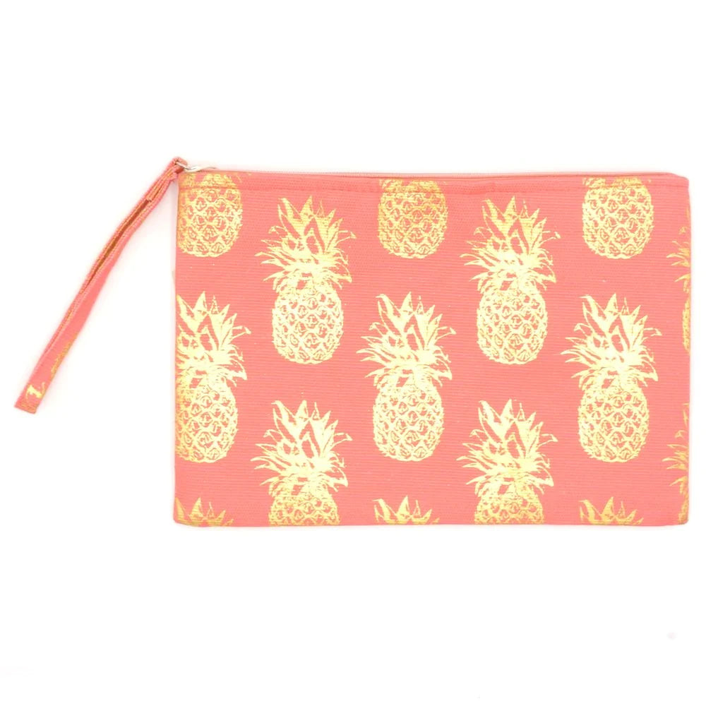 A pink wristlet bag with a gold metallic pineapple pattern and a zipper top closure.