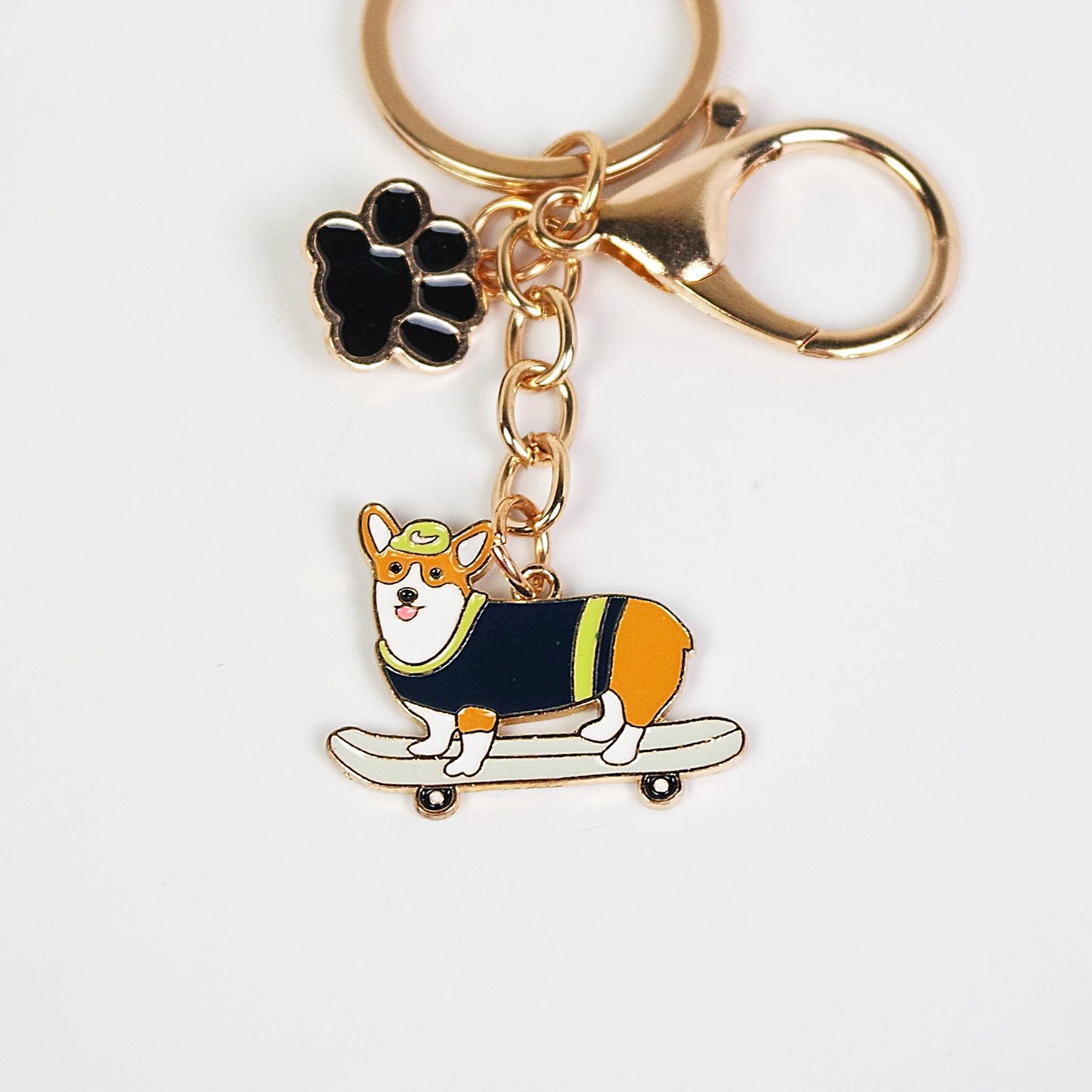 Keychain with a dog design and paw charm on a white background