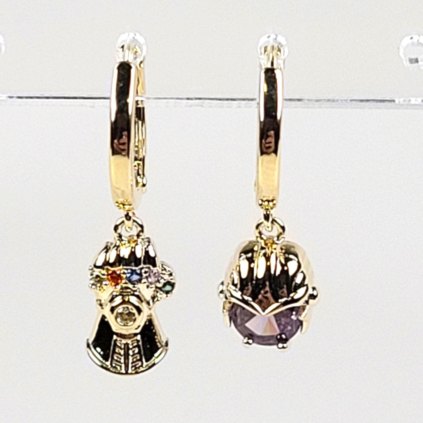 Gold earrings with gemstones on a white background