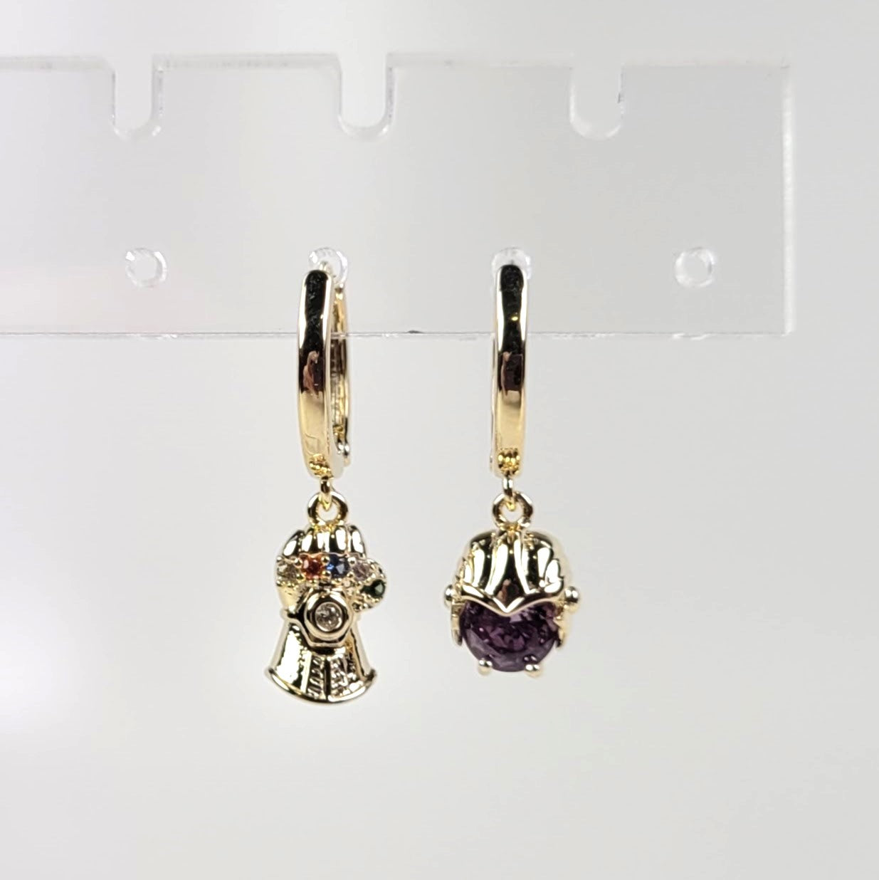 Gold earrings with gemstones on a white background