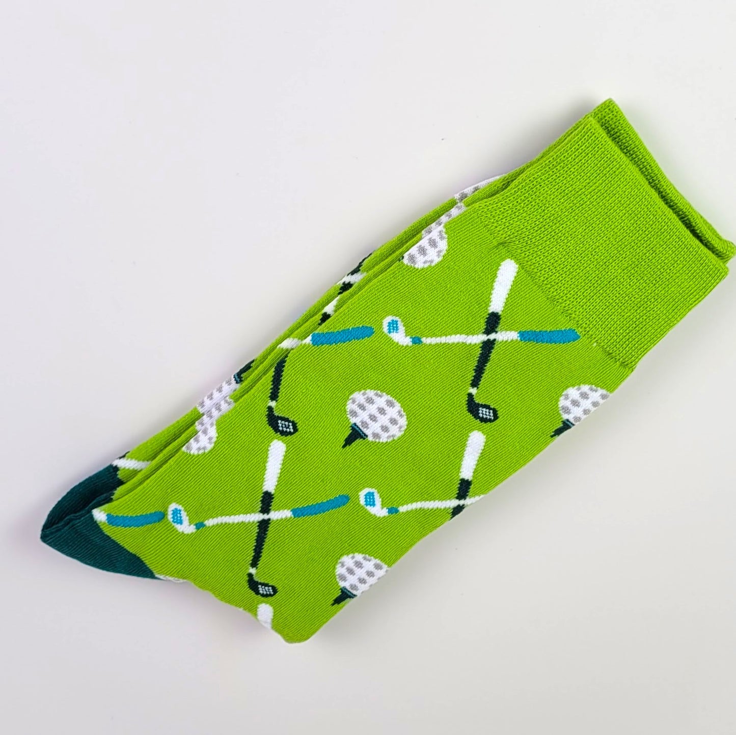 Green sock with golf-themed pattern on a light gray background