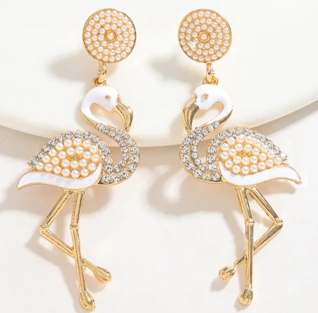 A pair of gold tone dangle earrings featuring a pearl adorned flamingo design.