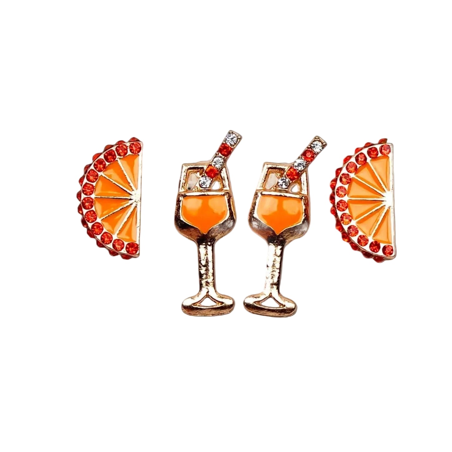 Set of earrings shaped like cocktail glasses and orange slices on a white background