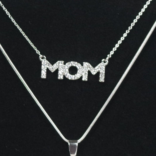Necklace and earrings set with 'MOM' pendant on a black stand.