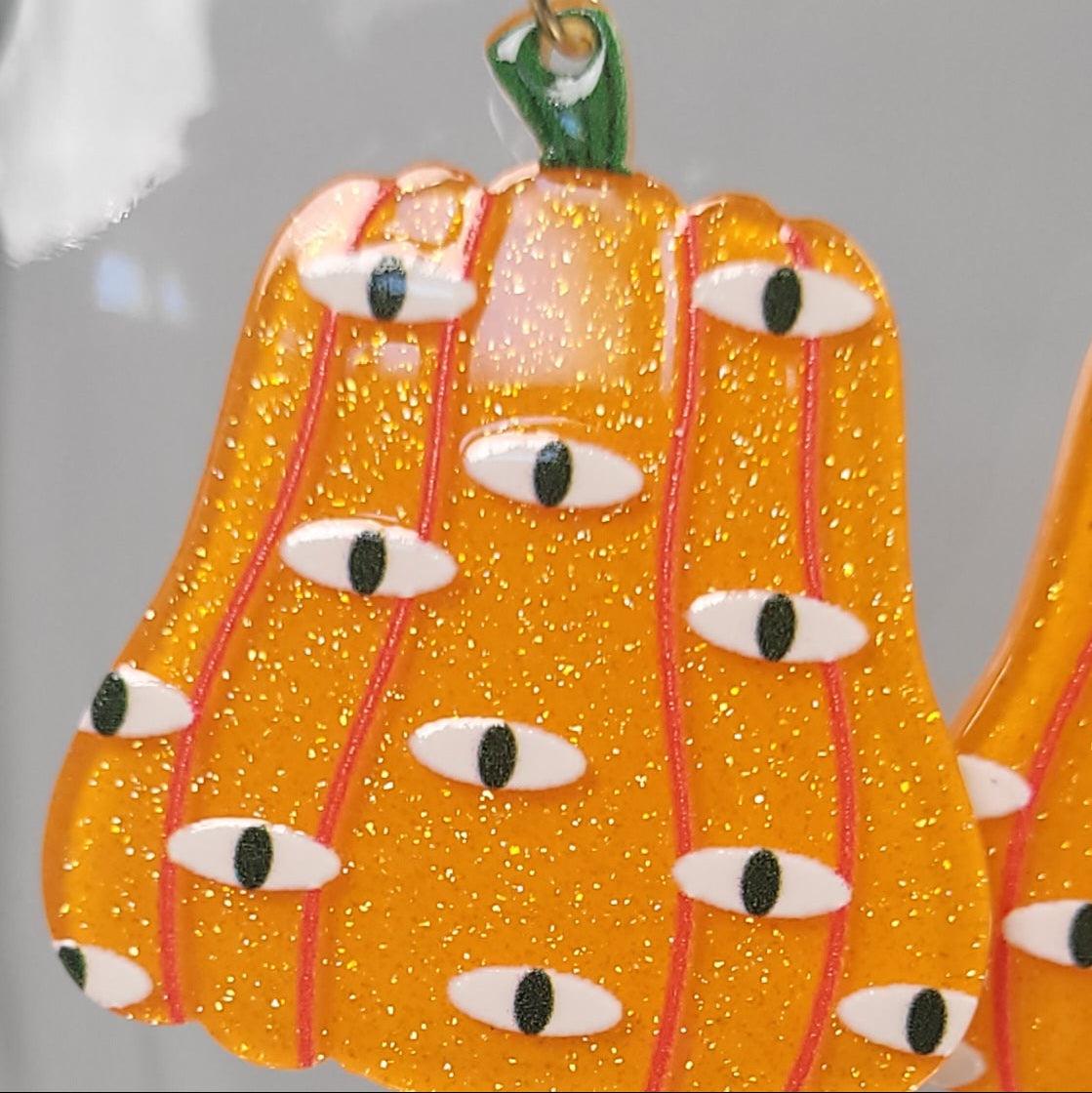 Decorative pumpkin ornament with eyes on a clear background
