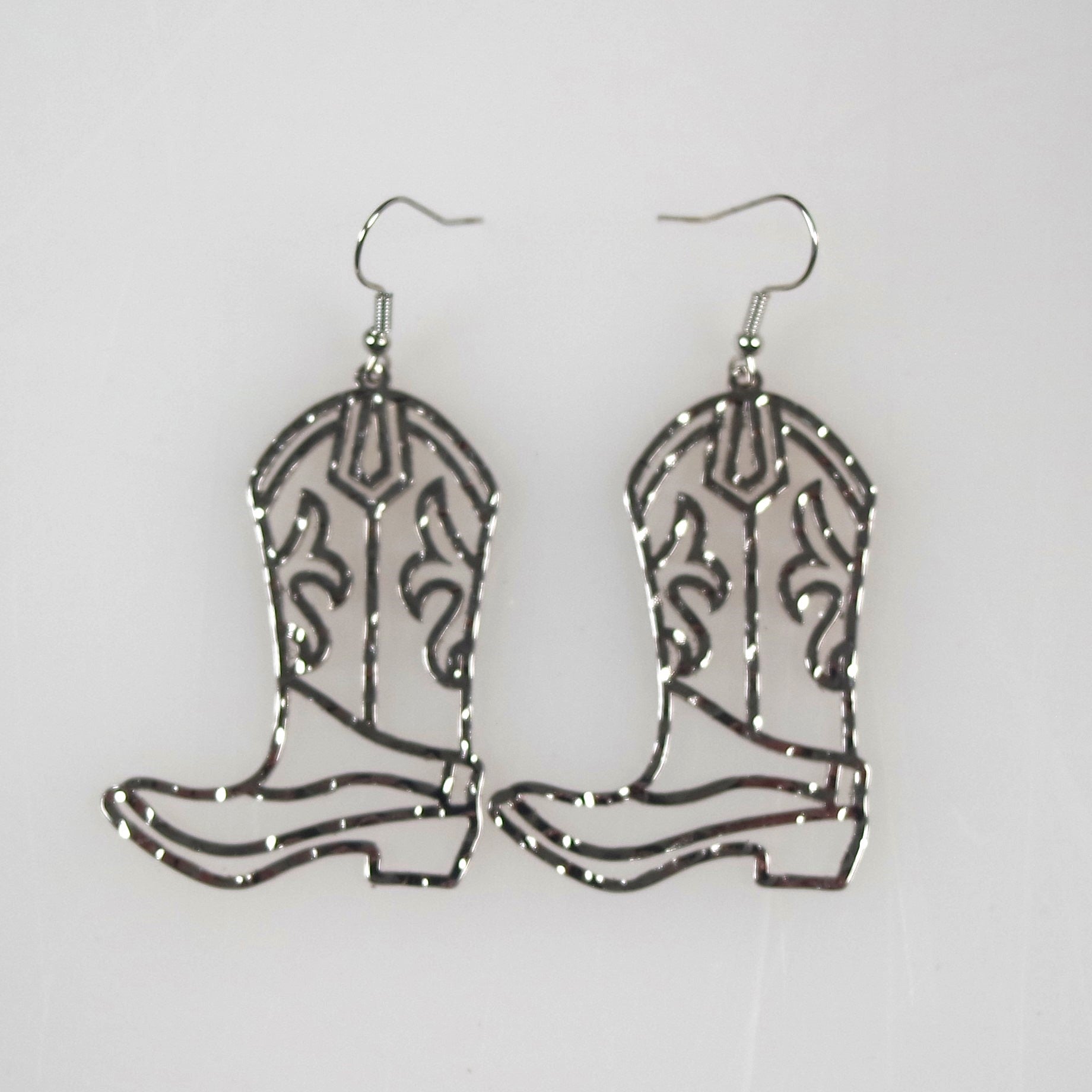 Cowboy boot-shaped earrings on a white background