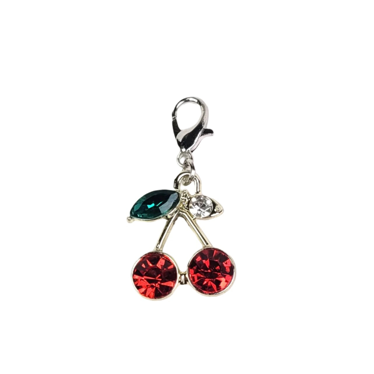 Cherry charm with red and green gemstones on a white background