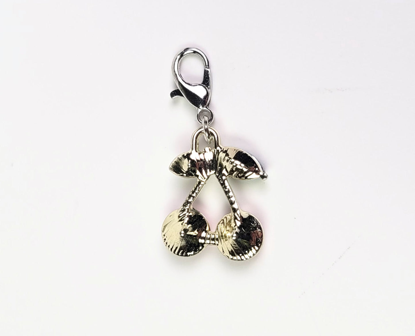 Gold and silver keychain charm on a white background