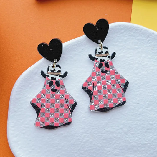 Pair of earrings with checkered dress design on a white and orange background