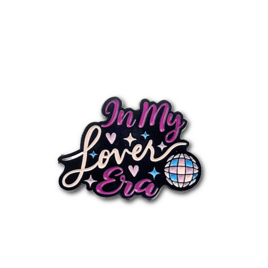 Decorative enamel pin with 'In My Lover Era' text and decorative elements on a white background