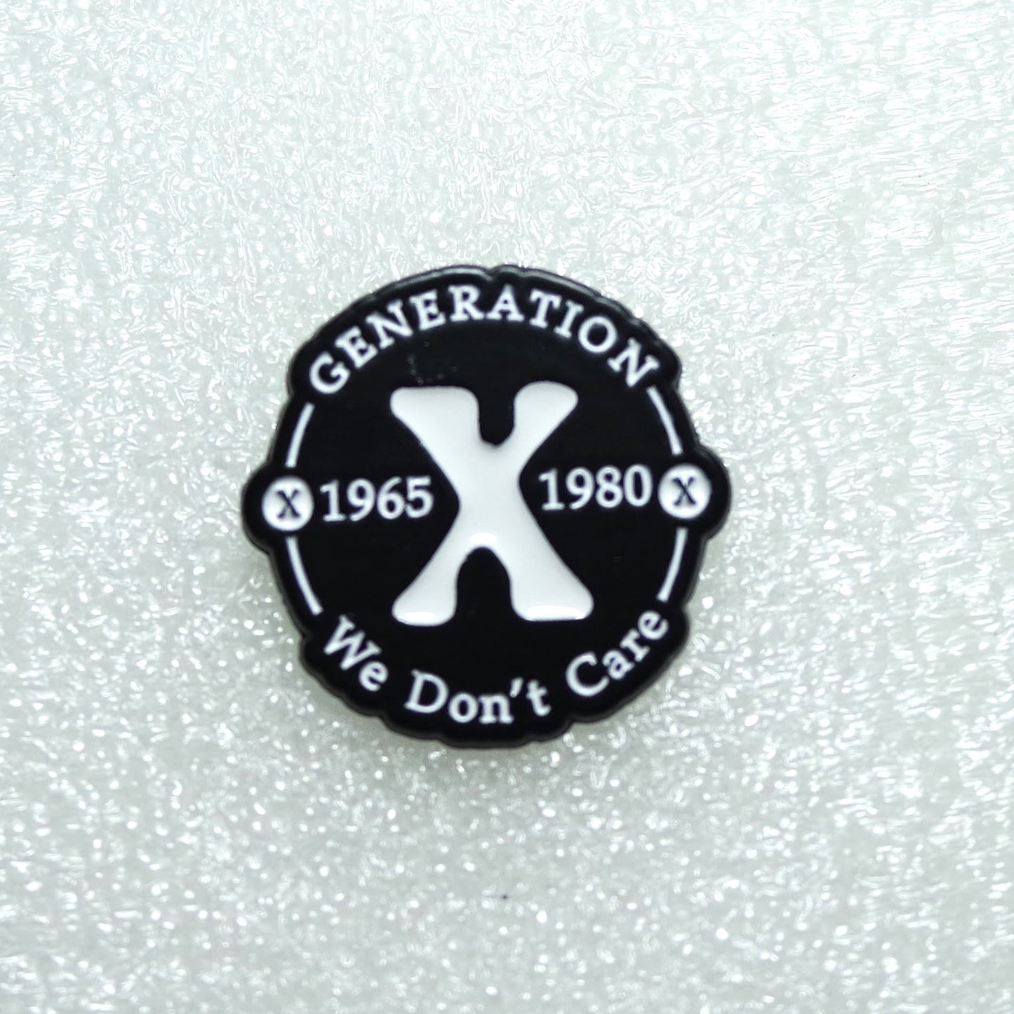 Round black badge with 'Generation X 1965 1980 We Don't Care' text on a textured white background