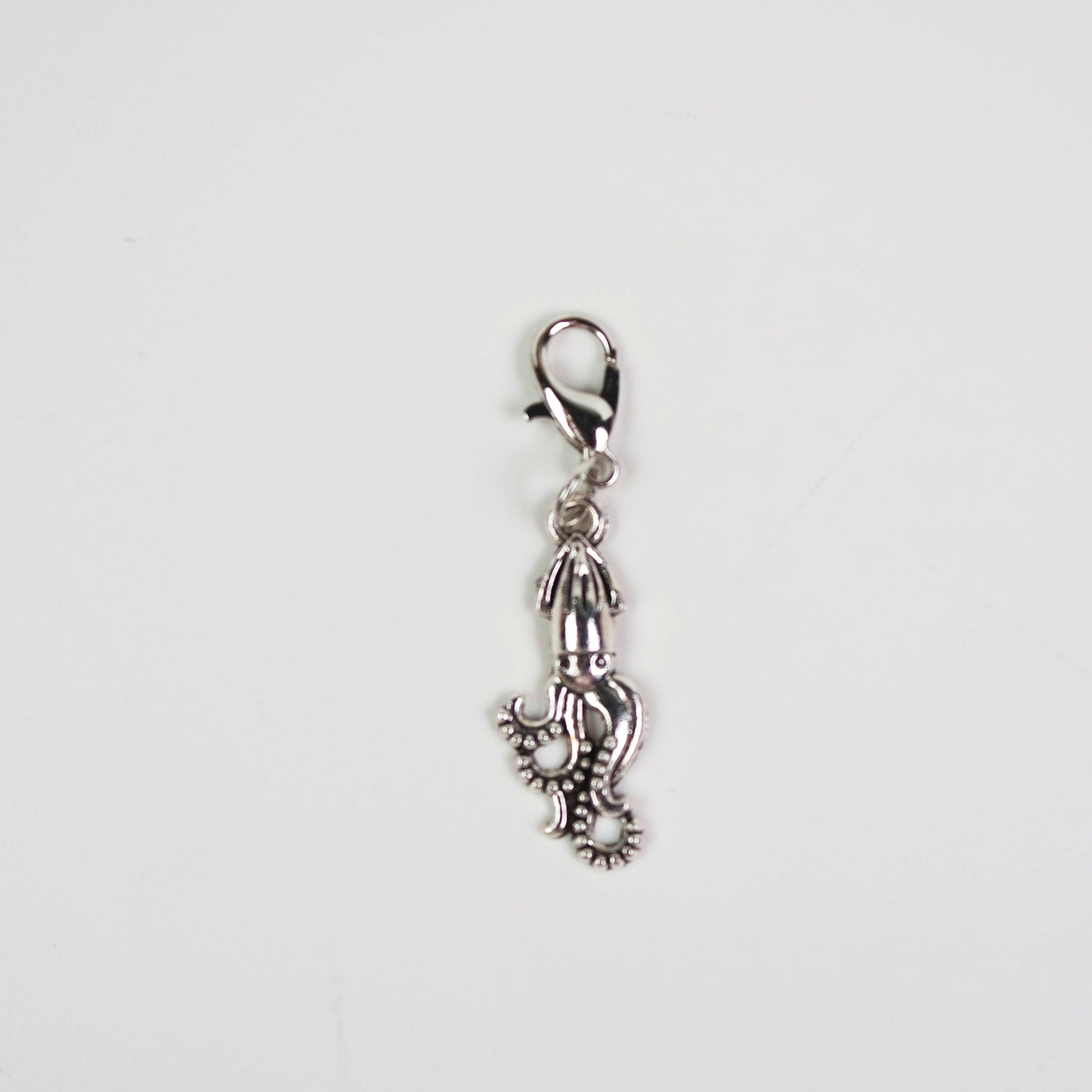 Silver Giant Squid charm with a lobster clasp on a white background