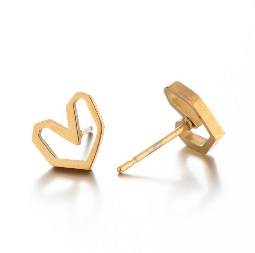 Gold heart-shaped earrings on a white background