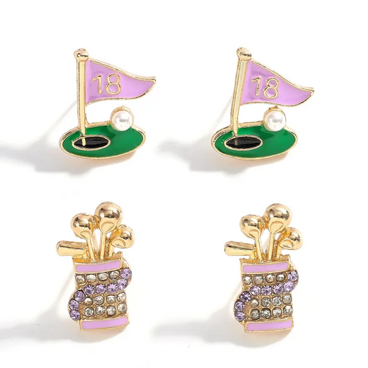 Golf-themed earrings with pink flags and green bases on a white background