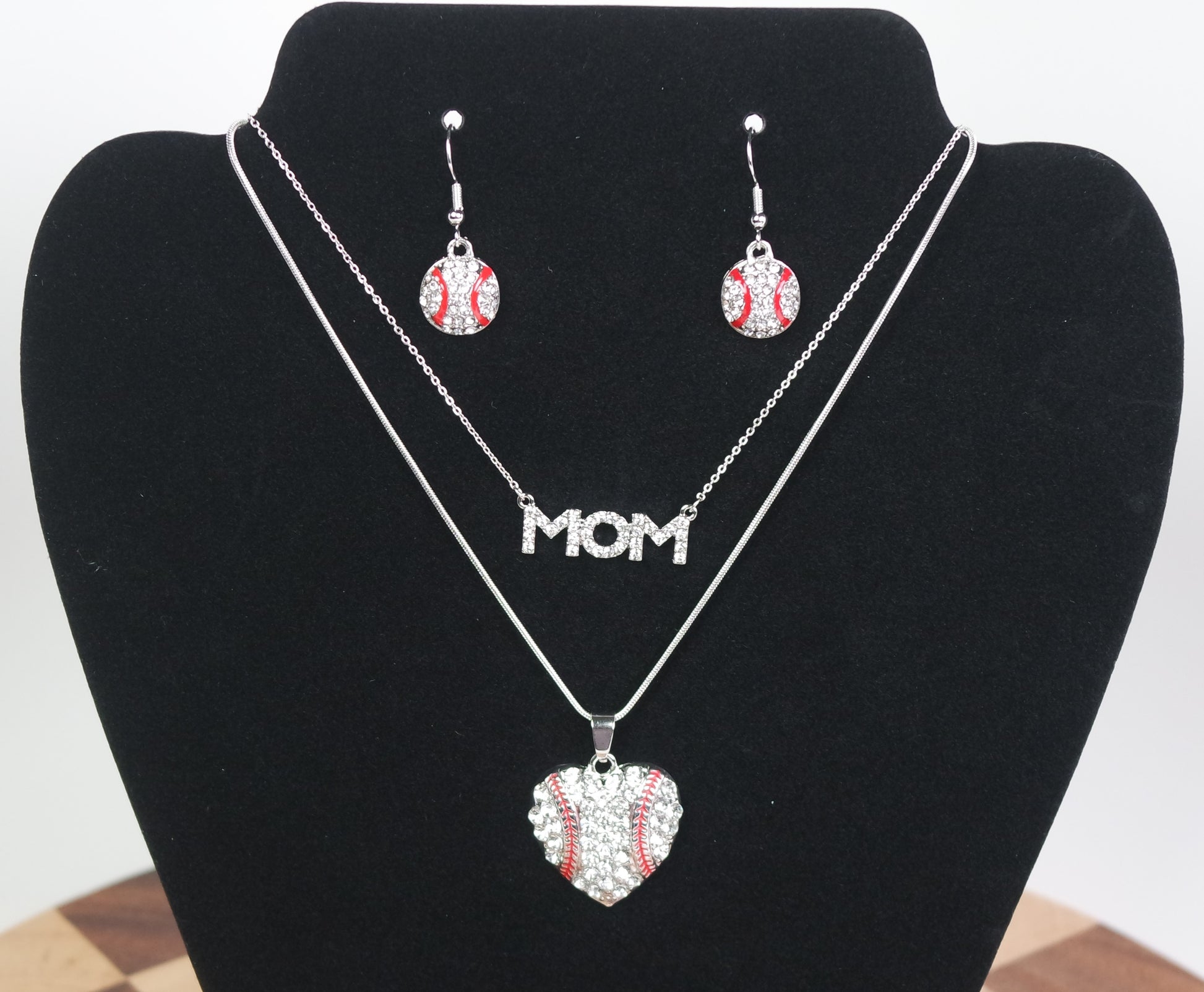 Jewelry set baseball mom - themed earrings on a black bust