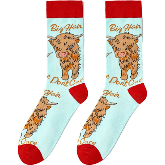 Pair of socks with highland cow design and text on a light blue background