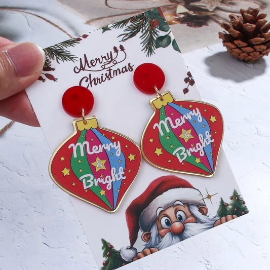 Christmas Ornament shape Dangle Earrings stating "Merry and Bright" On white background