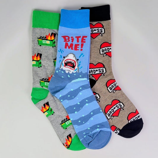 Three pairs of colorful socks with different designs on a light gray background