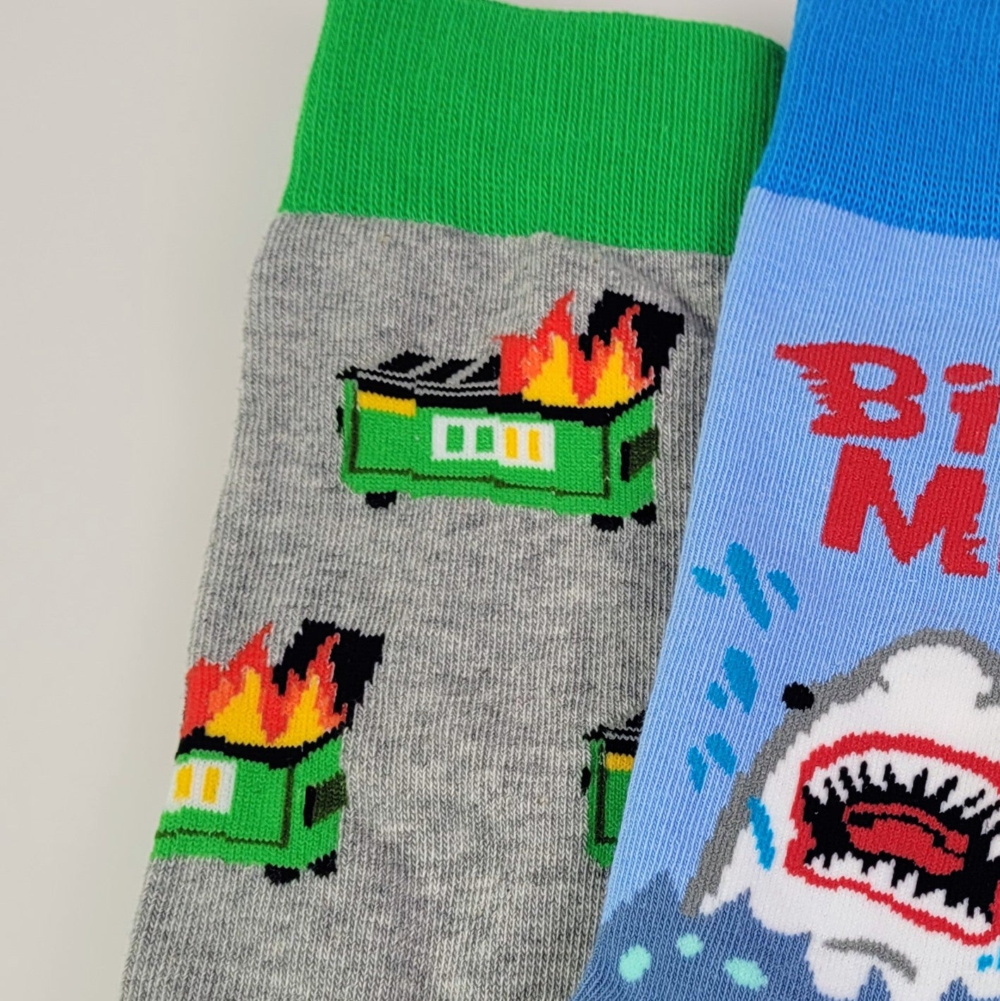 Close up view of a green dumpster on fire patterned socks