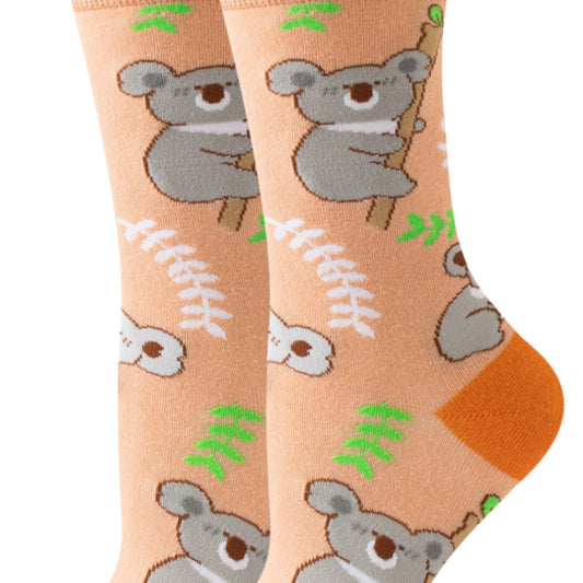 Pair of socks with koala bear and leaf pattern on a peach background