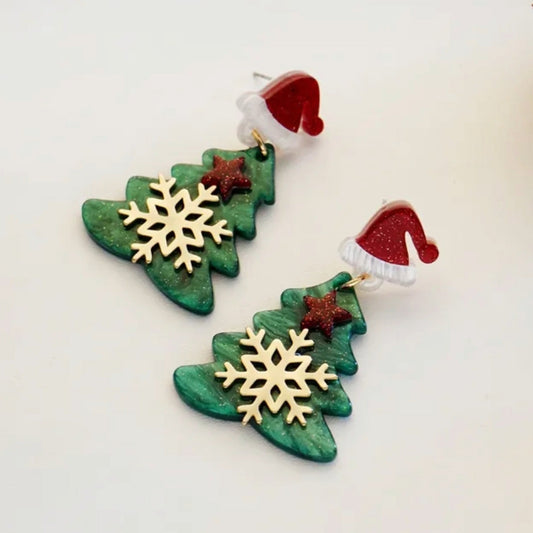Christmas-themed earrings with green tree shapes, gold snowflakes, and red Santa hats on a white background.