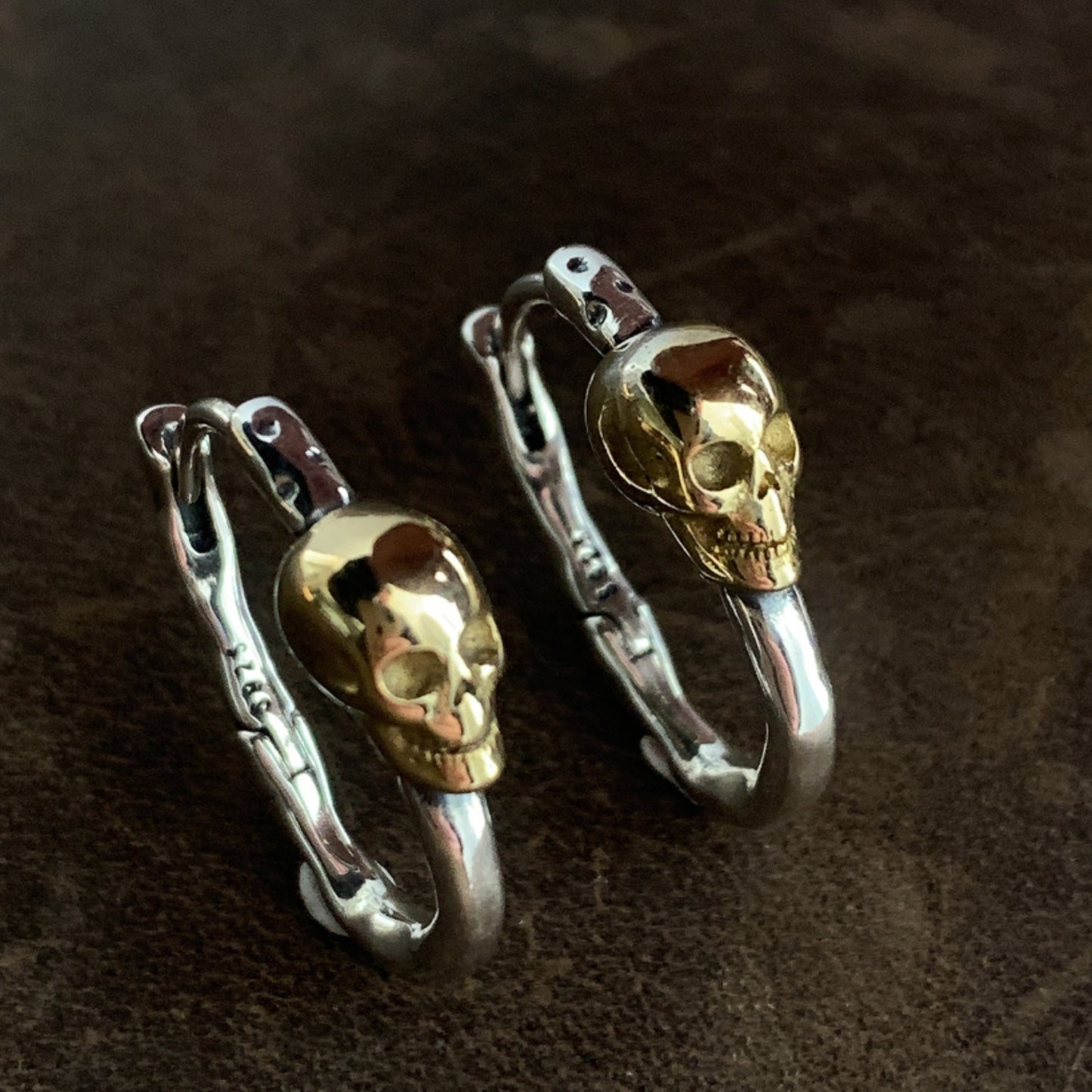 Skull-shaped hair clips on a dark brown background