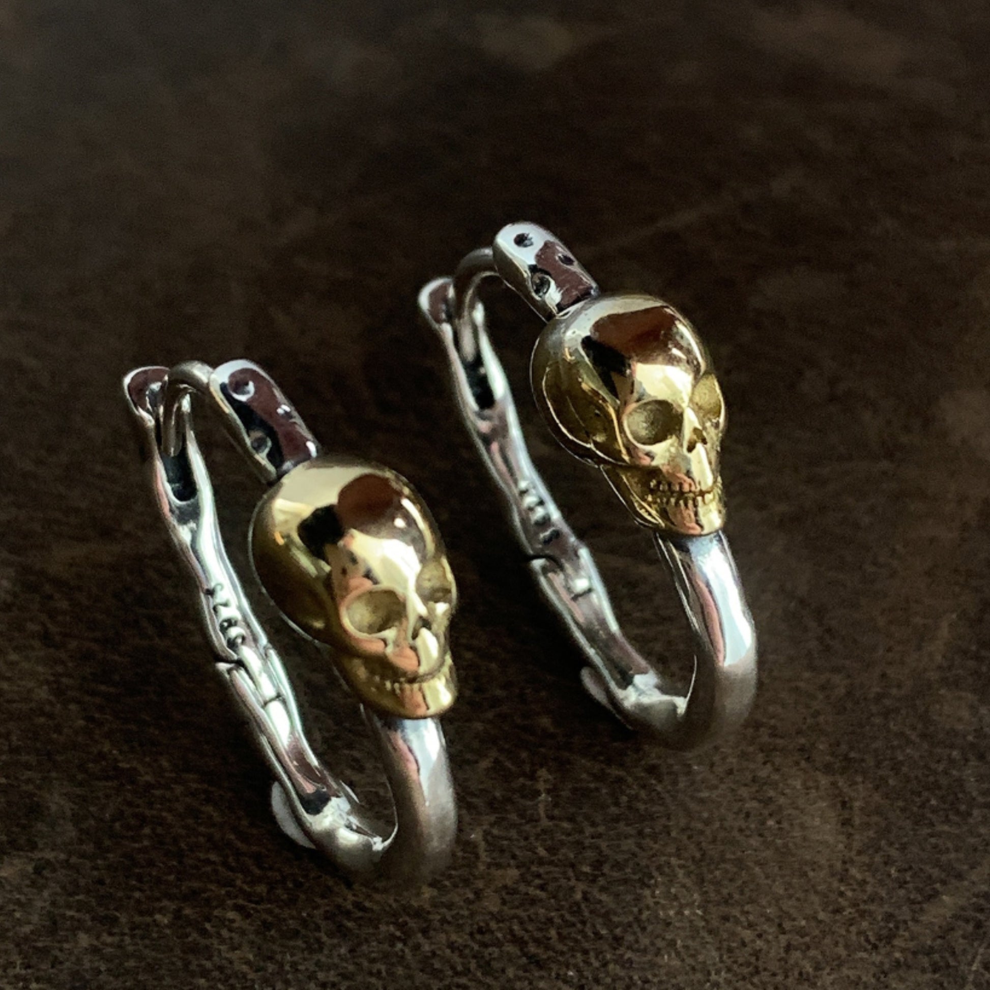 Skull-shaped hair clips on a dark brown background