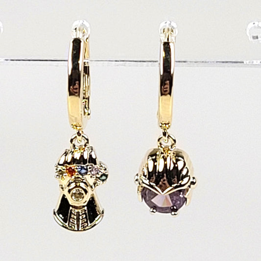 Gold earrings with gemstones on a white background
