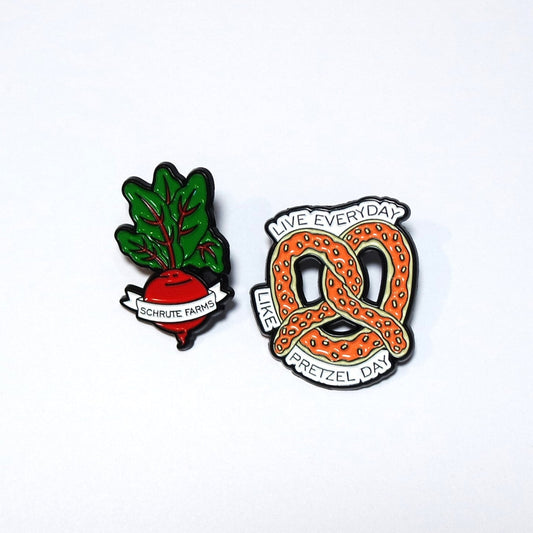 Two pins featuring a beet and a pretzel on a white background