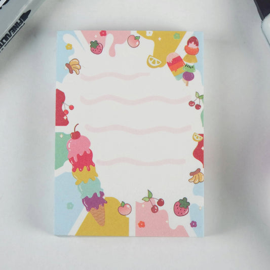 A small notepad with a cute ice cream design, featuring colorful illustrations of ice cream cones, fruits, and other playful elements on the cover.
