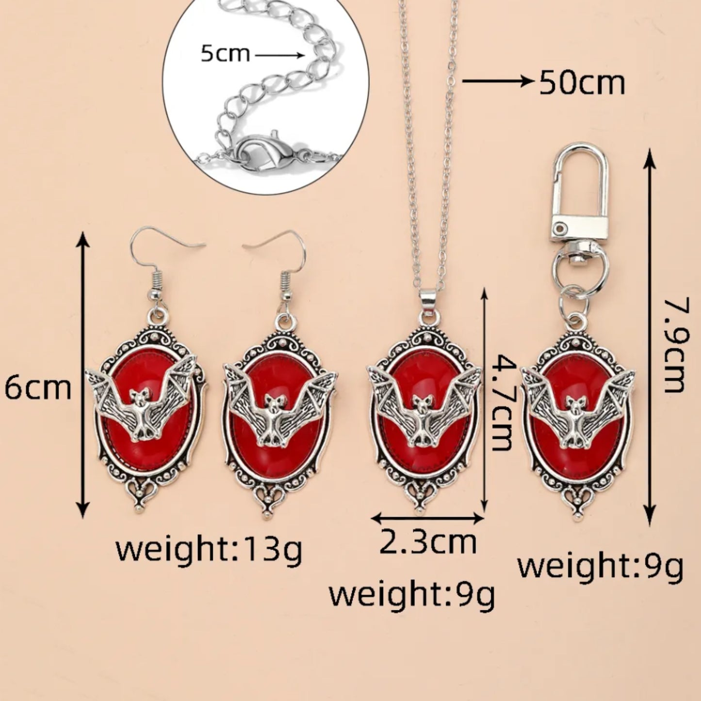 Jewelry set with red pendant, silver chain, and keychain on beige background
