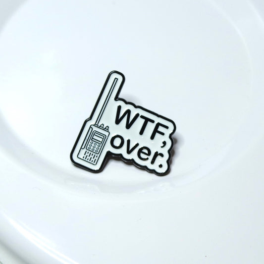 Enamel Pin with a walkie-talkie graphic and 'WTF, over.' text on a white background