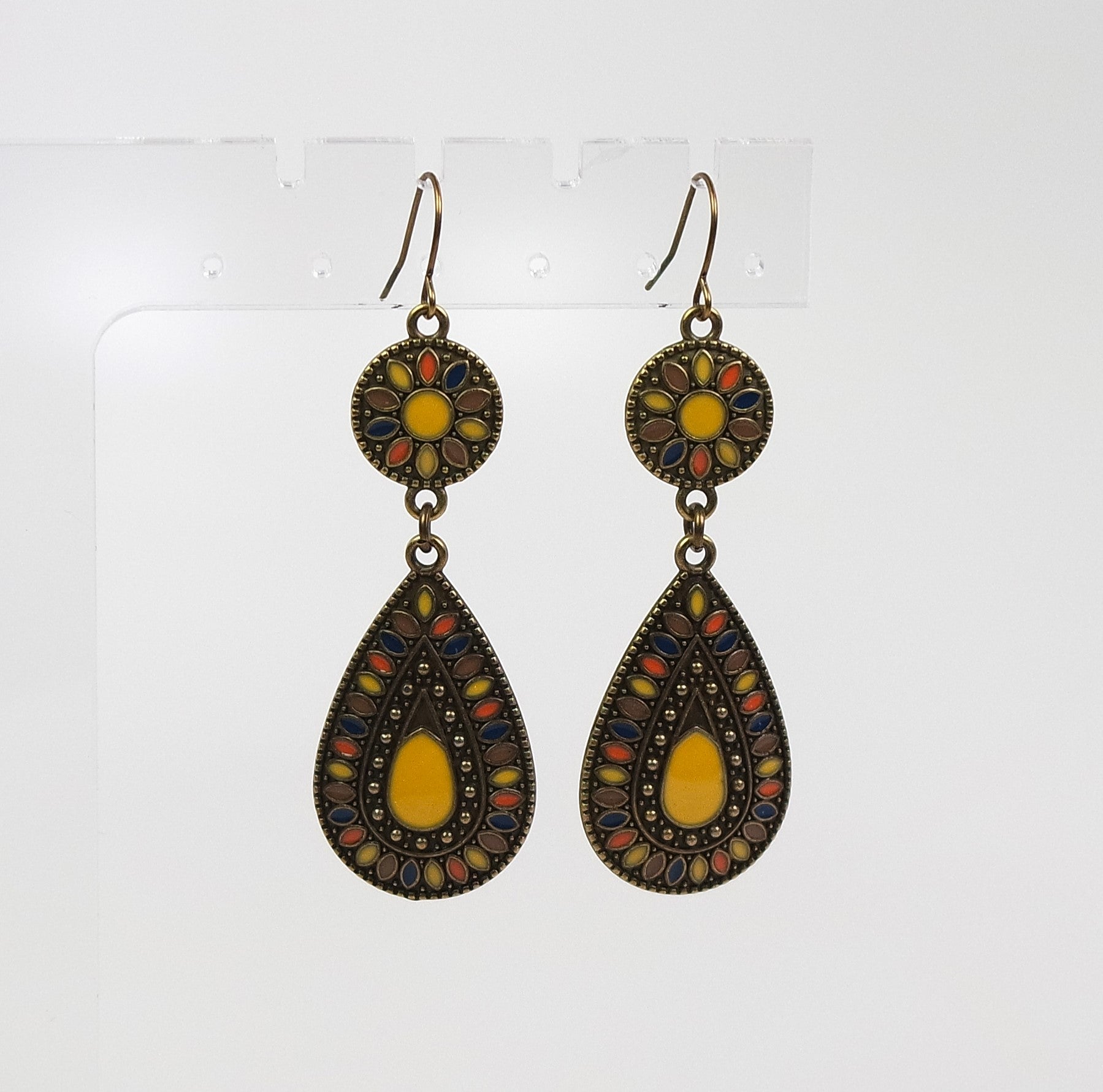 Pair of earrings with decorative designs on a white background