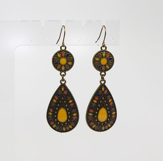 Pair of earrings with decorative designs on a white background