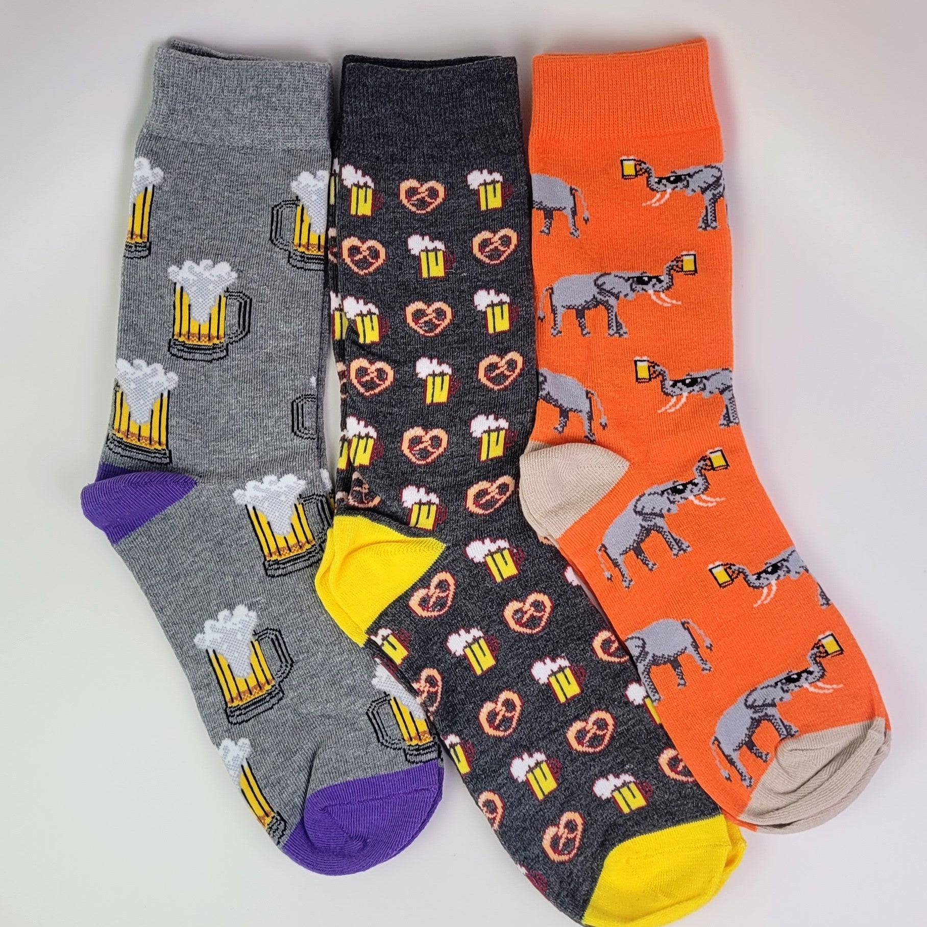 Three pairs of socks with different patterns on a white background