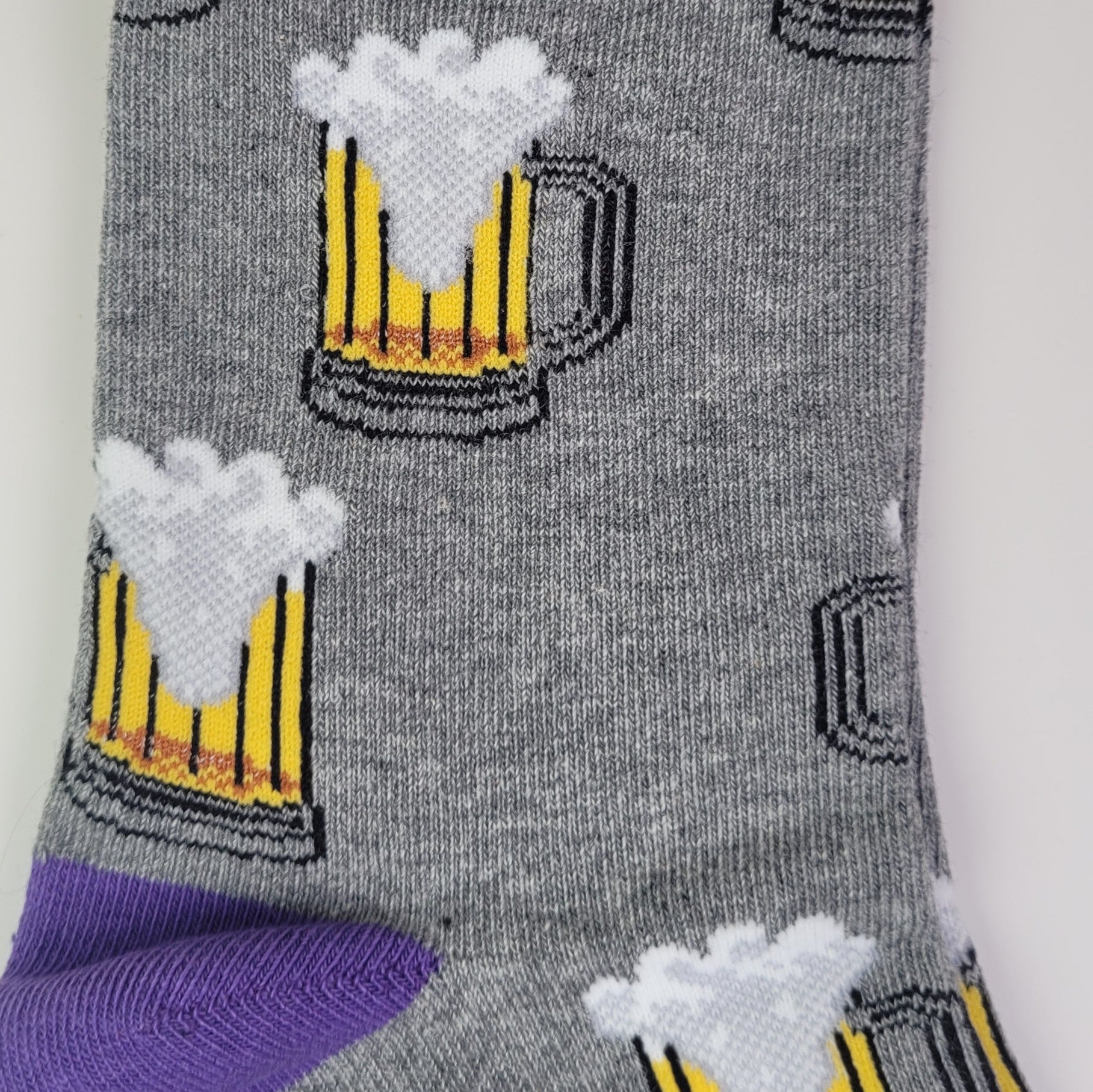 Gray sock with beer mug design on a white background