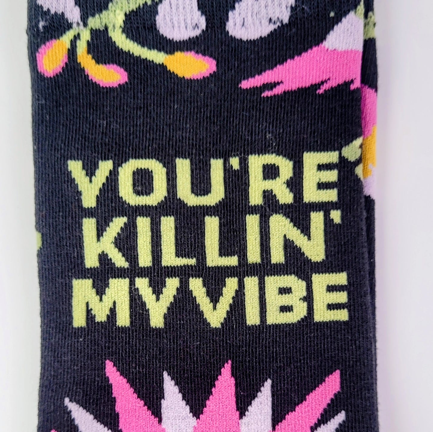 Sock with colorful text and floral design on a white background